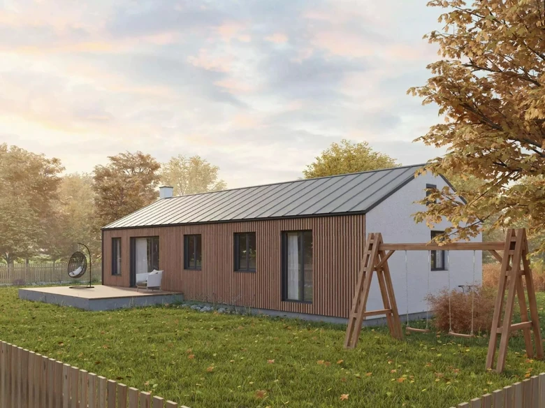 Moderní dřevěný bungalov s terasou a hřištěm na pozadí stromů.